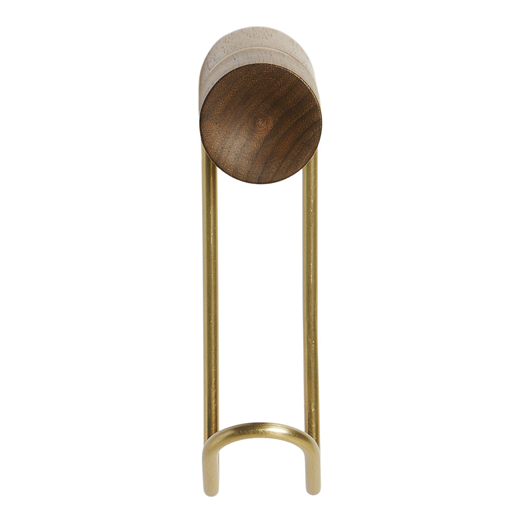 Modern brass stand with a wooden circular top, featuring a sleek, minimalist design in warm tones.