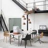 Modern dining room with a neutral palette, featuring black, tan, and earthy brown tones in furniture and decor.
