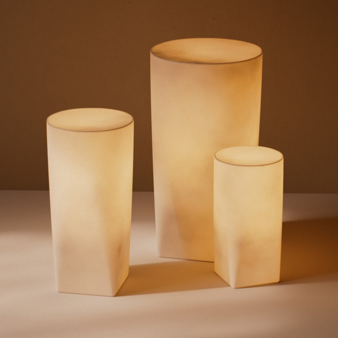 Soft beige and warm white illuminated lamp set with smooth, minimalist shapes. Perfect for ambient lighting.