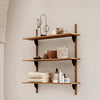 Wooden wall shelves with warm brown tones, featuring various neutral and natural textures against a light backdrop.
