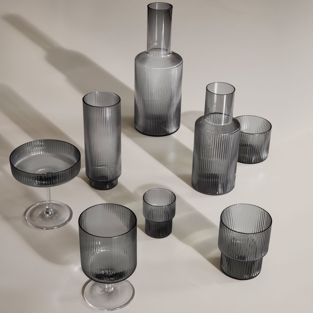 Assorted grey glassware featuring sleek, modern designs with subtle patterns and varying heights. Perfect for stylish dining.