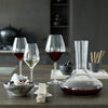 Elegant glassware setup featuring clear and colored glasses, a sleek carafe, and minimalistic black and white decor.