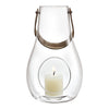 Clear glass lantern with a silver handle and circular base, featuring a creamy white candle inside.
