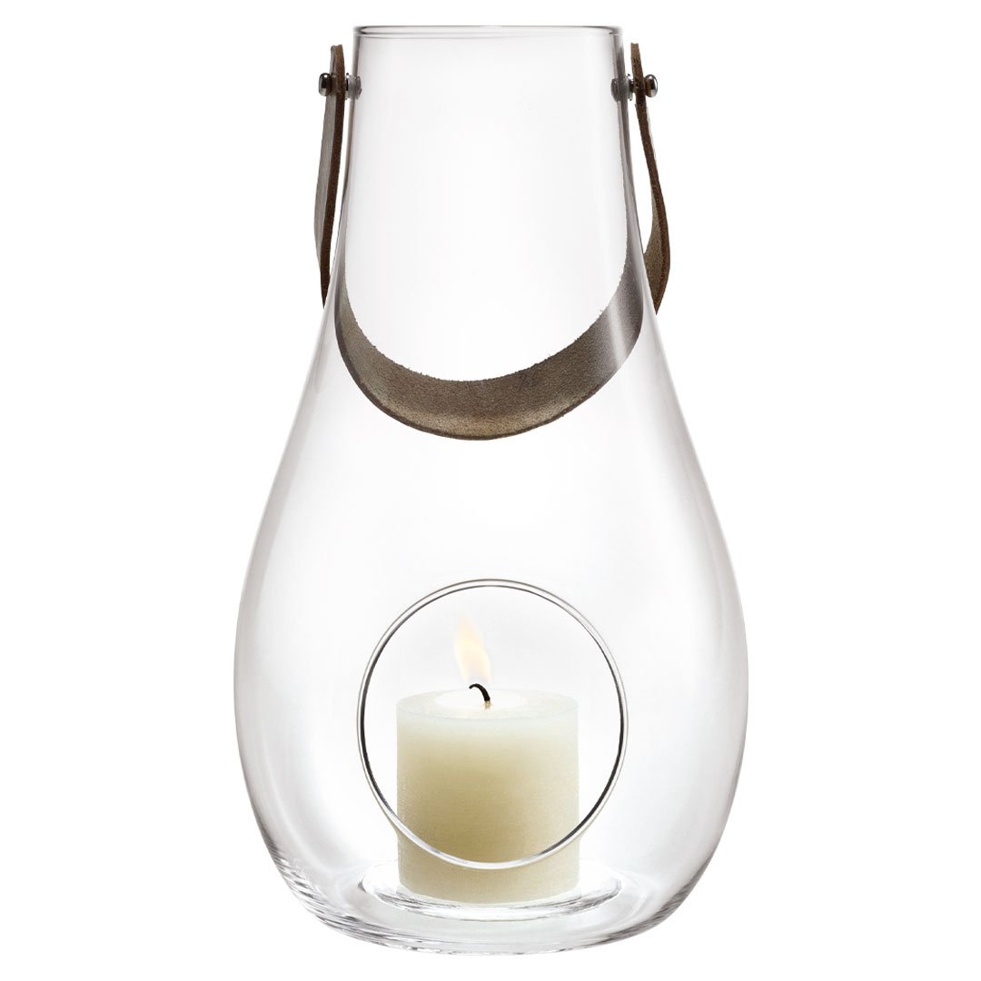 Clear glass lantern with sleek design, featuring a minimalist pattern and a soft white candle inside.