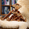 Wooden monkey figurines in warm brown tones, featuring smooth finishes and playful designs displayed on a cozy cream backdrop.