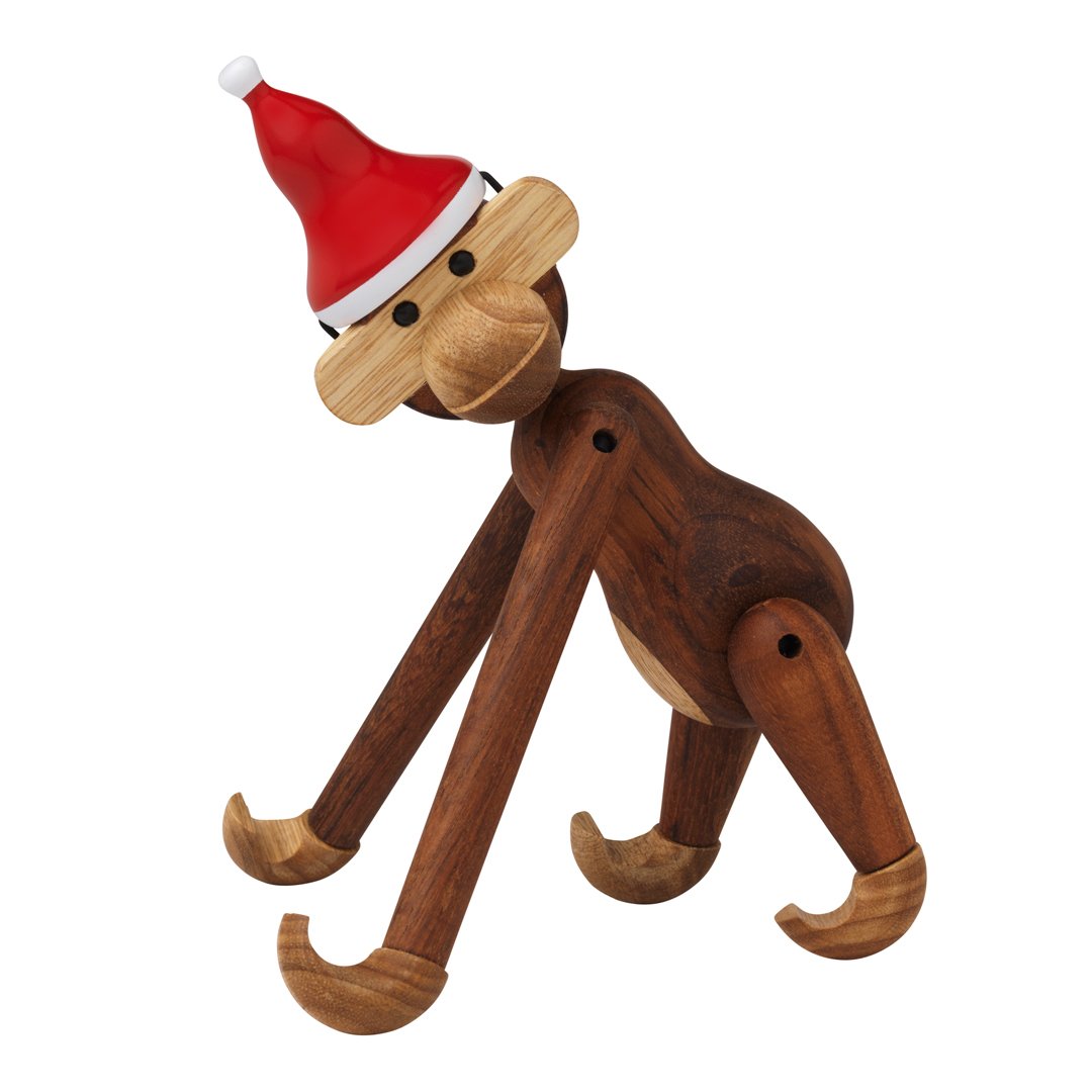 Wooden monkey figurine with a red Santa hat, featuring natural wood tones and playful, organic patterns.