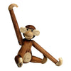 Wooden monkey figurine featuring rich brown tones and light beige accents, showcasing a playful, whimsical design.