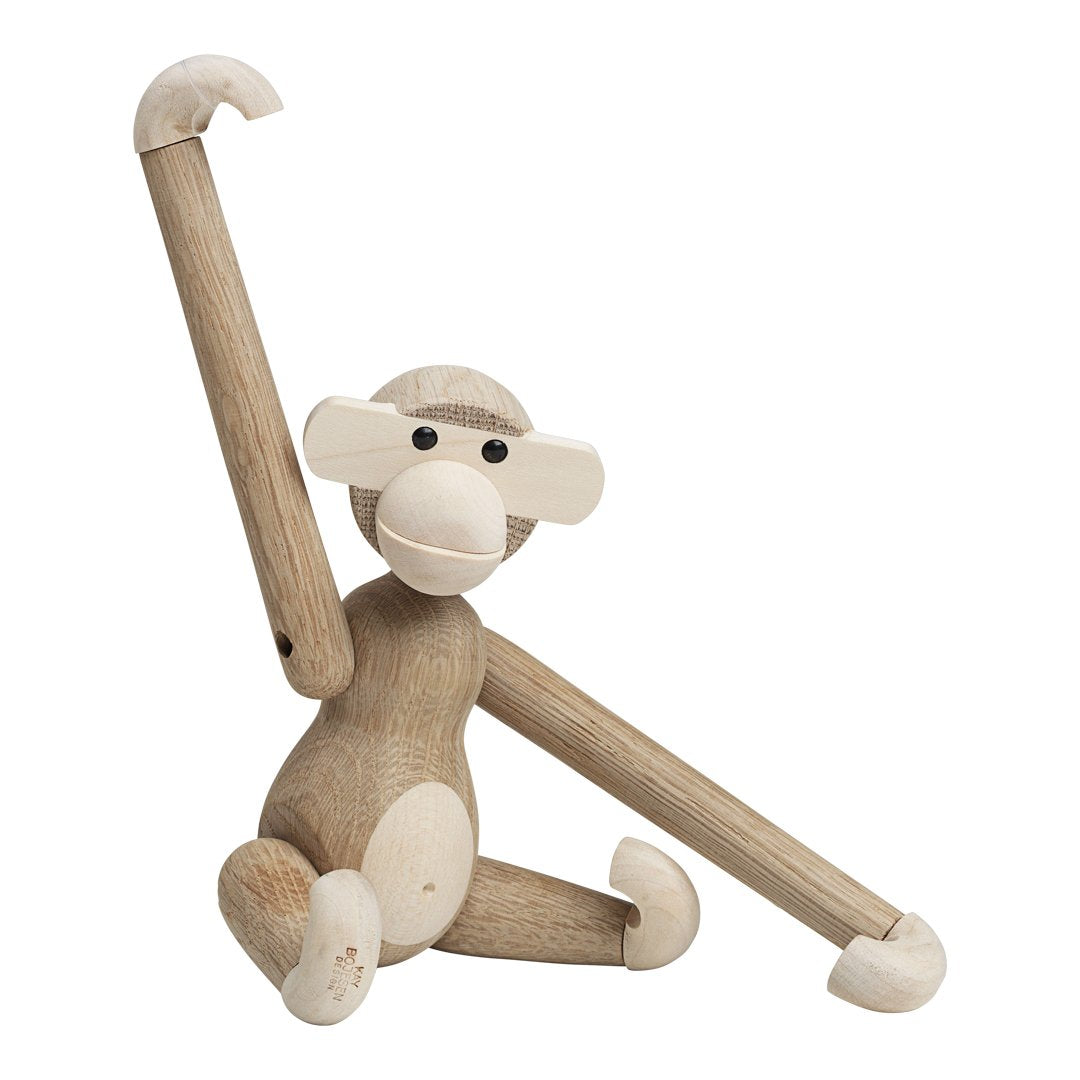 Wooden monkey figure in natural tones with cream accents and simple, playful design. Perfect for decor and gifts.