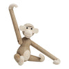 Wooden monkey figure in natural tones with cream accents and simple, playful design. Perfect for decor and gifts.