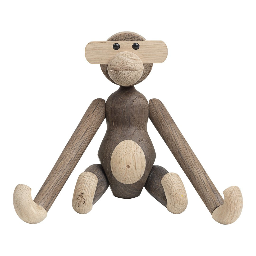 Wooden monkey figure featuring a mix of natural brown and light beige tones with smooth, rounded shapes.