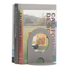 Gray bookend with a smooth finish, featuring a semi-circle cutout, positioned beside colorful design books.