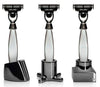 Three sleek, modern razors with polished silver and black accents, featuring unique base designs and stylish patterns.
